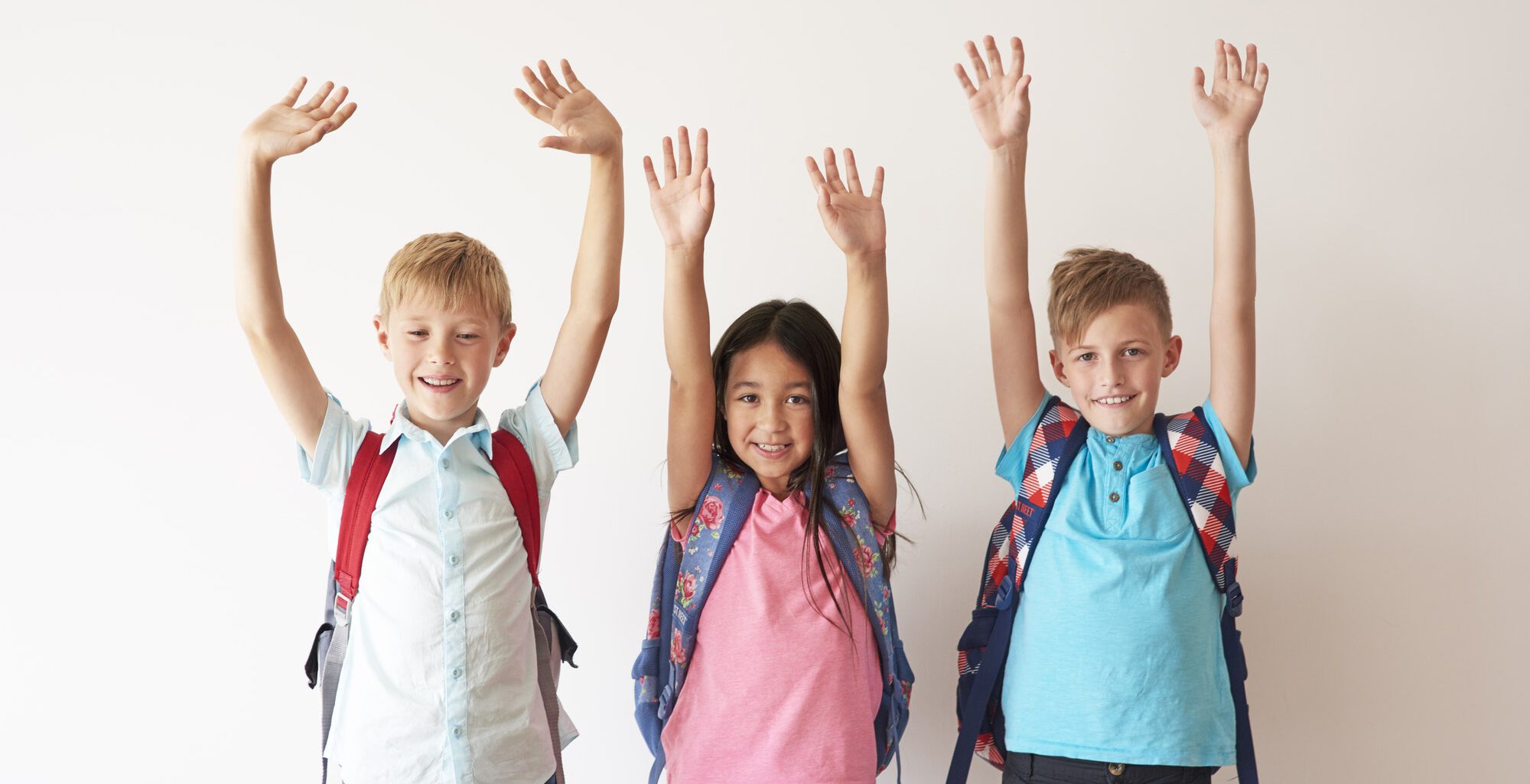 Children on white bakcground with hands up