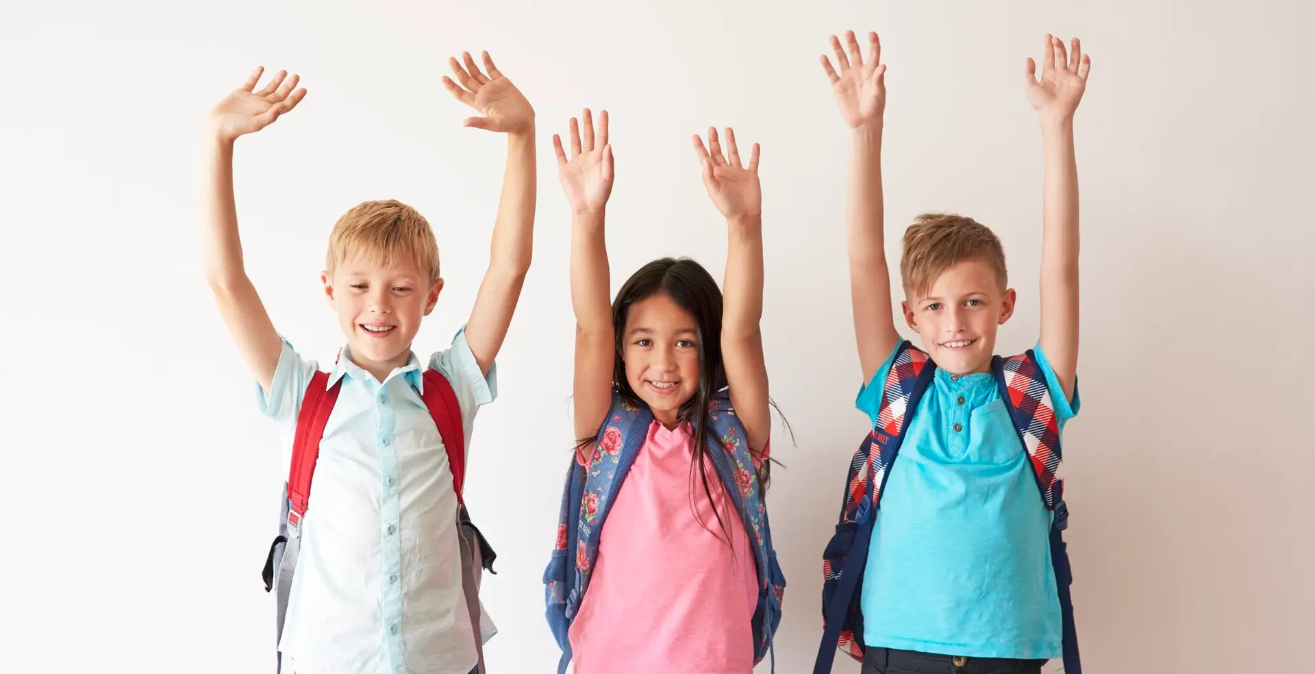 Children on white bakcground with hands up