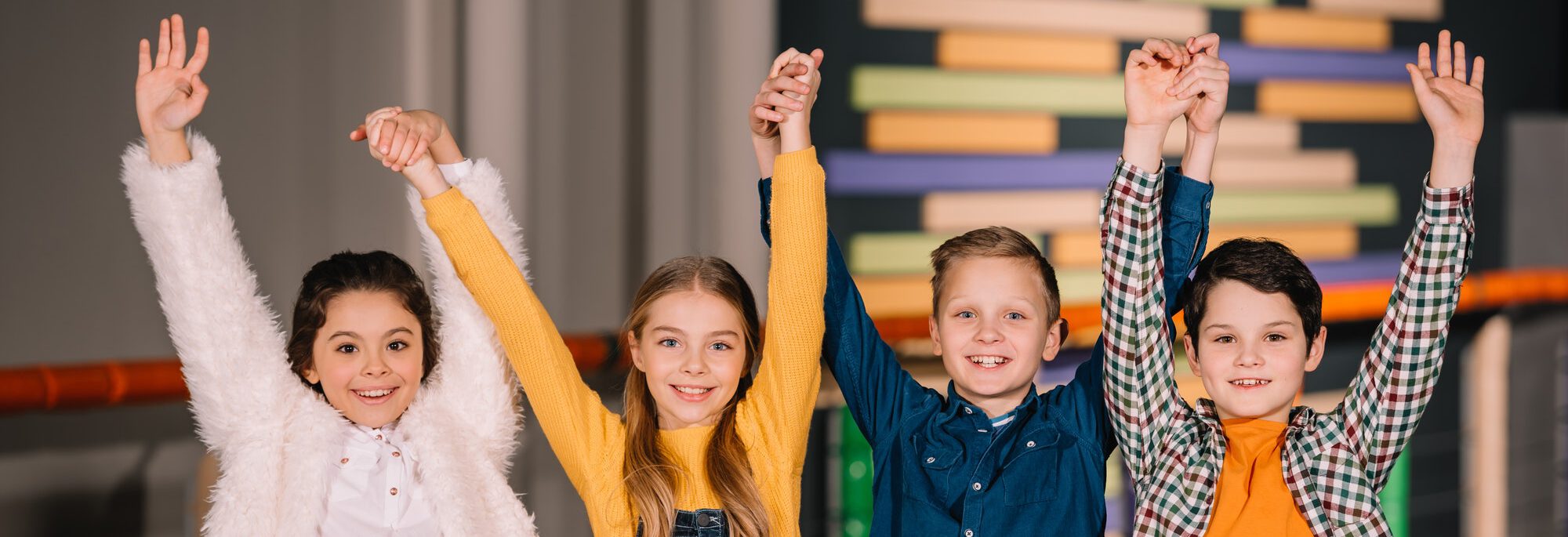 Children raising hands up and expressing happy emotions